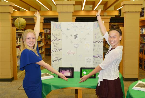 2 students displaying a project